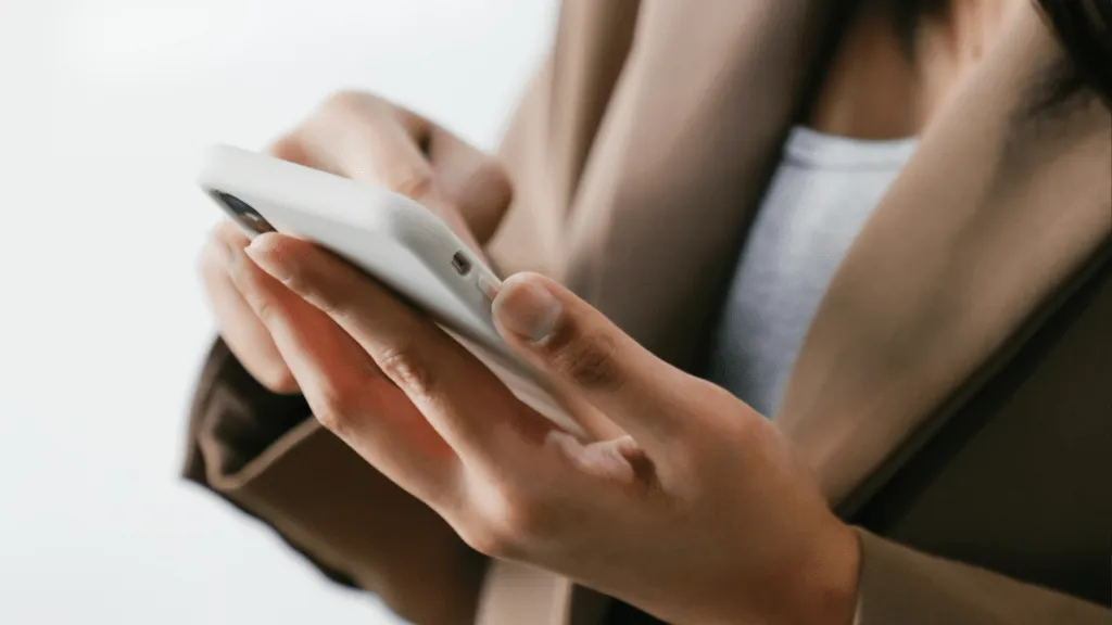 Close up of a woman scrolling on her mobile phone.
